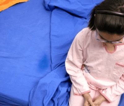 John K embarrassed young girl sitting on bed after wetting the bed